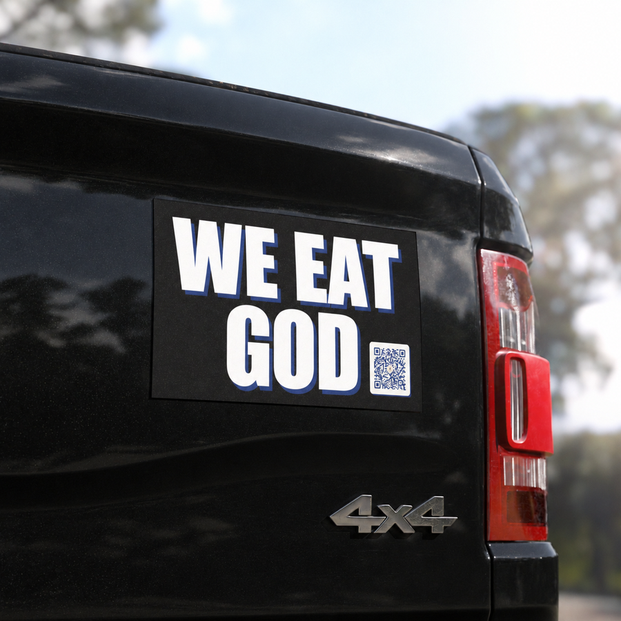 Close-up of the WE EAT GOD car magnet on the tailgate of a glossy black pickup truck